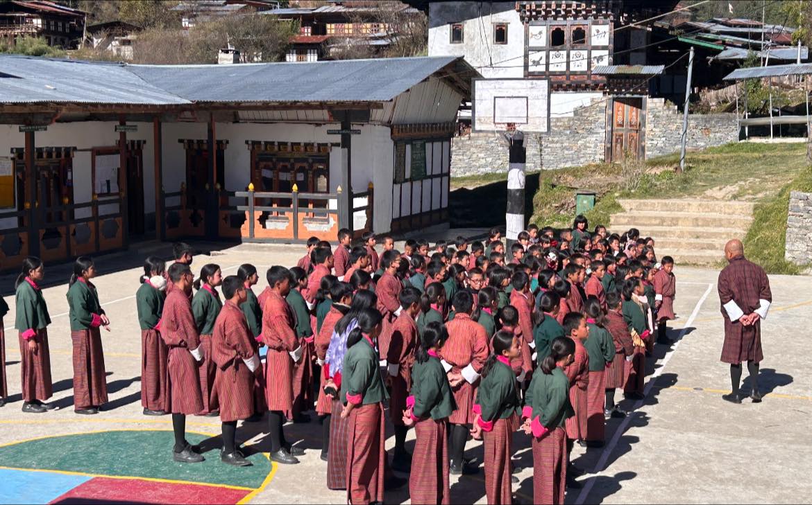 A quiet school landscape and community moment